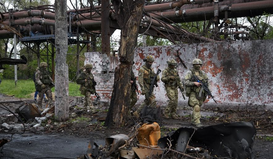 Russian troops walk in a destroyed part of the Illich Iron &amp; Steel Works Metallurgical Plant in Mariupol, in territory under the government of the Donetsk People&#39;s Republic, eastern Ukraine, May 18, 2022. This photo was taken during a trip organized by the Russian Ministry of Defense. Three months after it invaded Ukraine hoping to overtake the country in a blitz, Russia has bogged down in what increasingly looks like a war of attrition with no end in sight. (AP Photo, File)