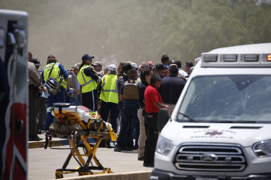 Emergency personnel gather near Robb Elementary School following a shooting, Tuesday, May 24, 2022, in Uvalde, Texas. (AP Photo/Dario Lopez-Mills)