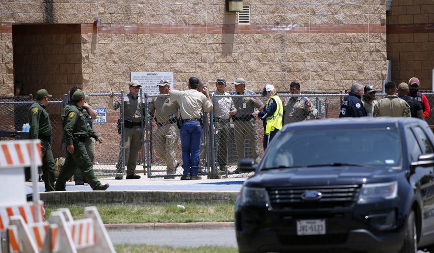 Law enforcement, and other first responders, gather outside Robb Elementary School following a shooting, Tuesday, May 24, 2022, in Uvalde, Texas. (AP Photo/Dario Lopez-Mills)