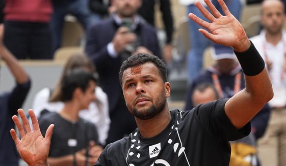France&#39;s Jo-Wilfried Tsonga has a mark on his forehead after kissing the clay after losing to Norway&#39;s Casper Ruud in a first round match of the French Open tennis tournament at the Roland Garros stadium Tuesday, May 24, 2022 in Paris. The Frenchman retired following his first-round loss against Casper Ruud. (AP Photo/Michel Euler) **FILE**