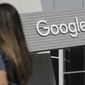 A woman walks below a Google sign on the campus in Mountain View, Calif., on Sept. 24, 2019. (AP Photo/Jeff Chiu, File)