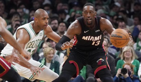 Miami Heat center Bam Adebayo (13) is pressured byBoston Celtics center Al Horford, left, during the second half of Game 4 of the NBA basketball playoffs Eastern Conference finals, Monday, May 23, 2022, in Boston. (AP Photo/Charles Krupa) **FILE**