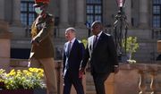 German Chancellor Olaf Scholz, center, walks with South Africa President Cyril Ramaphosa after the official welcoming ceremony at the Union Building in Pretoria, South Africa, Tuesday, May 24, 2022. (AP Photo/Themba Hadebe)