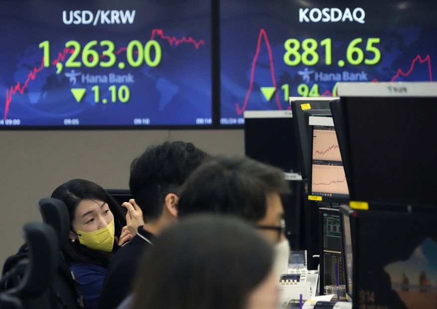 A currency trader watches monitors at the foreign exchange dealing room of the KEB Hana Bank headquarters in Seoul, South Korea, Tuesday, May 24, 2022.  Asian shares were mostly lower on Tuesday as worries over inflation tempered optimism over President Joe Biden’s remark that he was considering reducing U.S. tariffs on Chinese imports.(AP Photo/Ahn Young-joon)