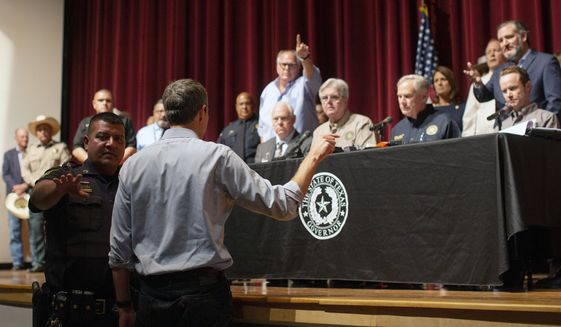 Democrat Beto O&#39;Rourke, who is running against Greg Abbott for governor in 2022, interrupts a news conference headed by Texas Gov. Greg Abbott in Uvalde, Texas Wednesday, May 25, 2022. (AP Photo/Dario Lopez-Mills)