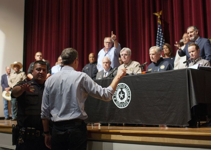 Democrat Beto O&#39;Rourke, who is running against Greg Abbott for governor in 2022, interrupts a news conference headed by Texas Gov. Greg Abbott in Uvalde, Texas Wednesday, May 25, 2022. (AP Photo/Dario Lopez-Mills)