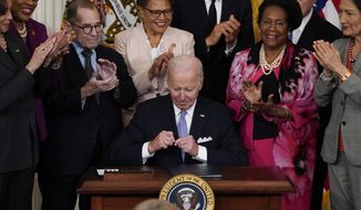 President Joe Biden signs an executive order in the East Room of the White House, Wednesday, May 25, 2022, in Washington. The order comes on the second anniversary of George Floyd&#39;s death, and is focused on policing. (AP Photo/Alex Brandon)