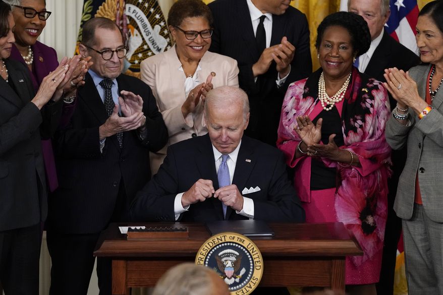 President Joe Biden signs an executive order in the East Room of the White House, Wednesday, May 25, 2022, in Washington. The order comes on the second anniversary of George Floyd's death, and is focused on policing. (AP Photo/Alex Brandon)