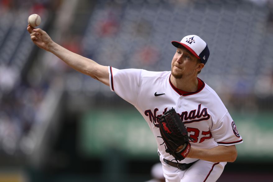 Washington Nationals starting pitcher Erick Fedde throws during the first inning of a baseball game against the Los Angeles Dodgers, Wednesday, May 25, 2022, in Washington. (AP Photo/Nick Wass)