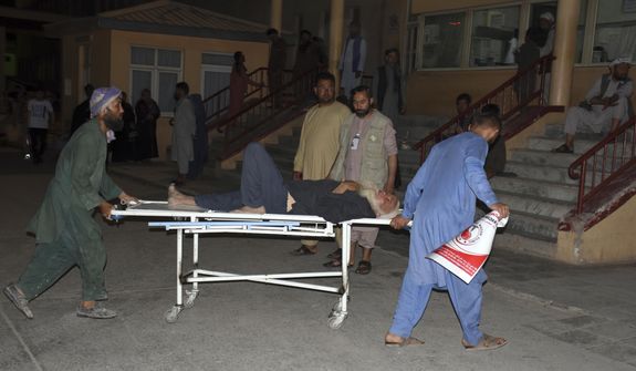 An injured man is transported to a hospital after a bombing in Mazar-e-Sharif, northern Afghanistan, Wednesday, May 25, 2022. A series of explosions shook Afghanistan on Wednesday, the Taliban said, including a blast inside a mosque in the capital of Kabul that killed at least five worshippers and three bombings of minivans in the country&#39;s north that killed nine passengers. (AP Photo/Masih Paeiz)