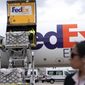 Workers unload a Fedex Express cargo plane carrying 100,000 pounds of baby formula at Washington Dulles International Airport, in Chantilly, Va., on Wednesday, May 25, 2022. (AP Photo/Jose Luis Magana)