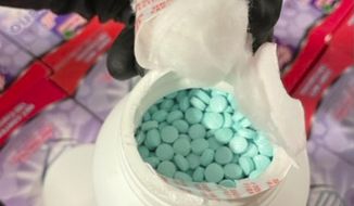 This photo released by the Casa Grande Police Department shows a collagen supplement bottle that concealed approximately 500,000 fentanyl pills found in an SUV pulled over for speeding on Interstate 10 in Pinal County, Arix., on Monday, May 23, 2022. (Casa Grande Police Department via AP) ** FILE **