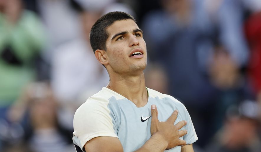 Spain&#39;s Carlos Alcaraz celebrates winning against Spain&#39;s Albert Ramos-Vinolas in five sets, 6-1, 6-7 (7-9), 5-7, 7-6 (7-2), 6-4, during their second round match at the French Open tennis tournament in Roland Garros stadium in Paris, France, Wednesday, May 25, 2022. (AP Photo/Jean-Francois Badias) **FILE**
