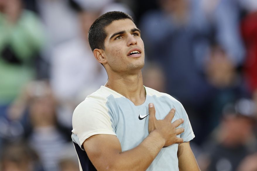 Spain&#39;s Carlos Alcaraz celebrates winning against Spain&#39;s Albert Ramos-Vinolas in five sets, 6-1, 6-7 (7-9), 5-7, 7-6 (7-2), 6-4, during their second round match at the French Open tennis tournament in Roland Garros stadium in Paris, France, Wednesday, May 25, 2022. (AP Photo/Jean-Francois Badias) **FILE**