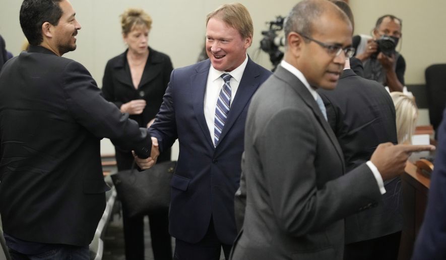 Jon Gruden, center, appears in court Wednesday, May 25, 2022, in Las Vegas. A Nevada judge heard a bid Wednesday by the National Football League to dismiss former Las Vegas Raiders coach Jon Gruden&#39;s lawsuit accusing the league of a &amp;quot;malicious and orchestrated campaign&amp;quot; including the leaking of offensive emails ahead of his resignation last October. (AP Photo/John Locher)