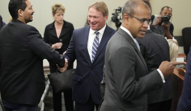 Jon Gruden, center, appears in court Wednesday, May 25, 2022, in Las Vegas. A Nevada judge heard a bid Wednesday by the National Football League to dismiss former Las Vegas Raiders coach Jon Gruden&#x27;s lawsuit accusing the league of a &amp;quot;malicious and orchestrated campaign&amp;quot; including the leaking of offensive emails ahead of his resignation last October. (AP Photo/John Locher)