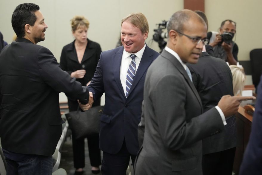 Jon Gruden, center, appears in court Wednesday, May 25, 2022, in Las Vegas. A Nevada judge heard a bid Wednesday by the National Football League to dismiss former Las Vegas Raiders coach Jon Gruden&#39;s lawsuit accusing the league of a &amp;quot;malicious and orchestrated campaign&amp;quot; including the leaking of offensive emails ahead of his resignation last October. (AP Photo/John Locher)