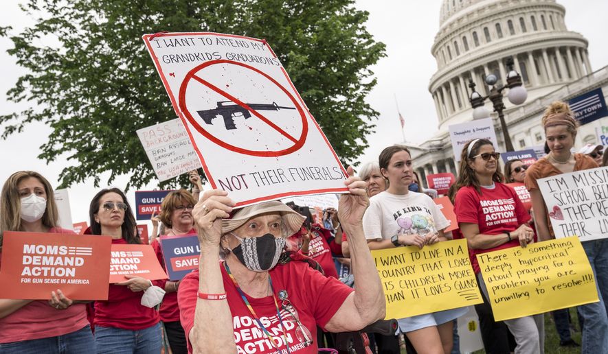 Activists join Senate Democrats outside the Capitol to demand action on gun control legislation after a gunman killed 19 children and two teachers in a Texas elementary school this week, in Washington, Thursday, May 26, 2022. (AP Photo/J. Scott Applewhite)