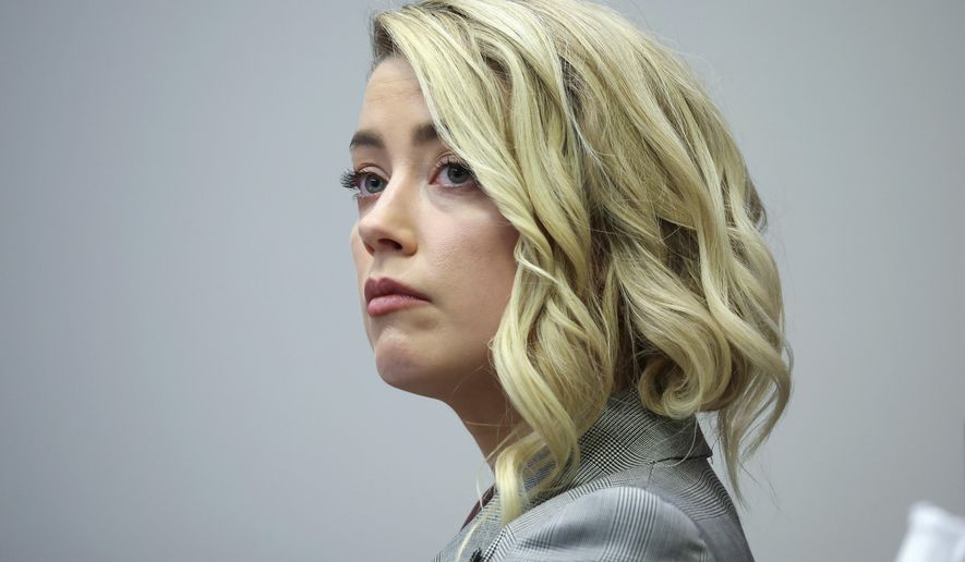 Actor Amber Heard appears in the courtroom in the Fairfax County Circuit Courthouse in Fairfax, Va., Thursday, May 26, 2022. Actor Johnny Depp sued his ex-wife Amber Heard for libel in Fairfax County Circuit Court after she wrote an op-ed piece in The Washington Post in 2018 referring to herself as a &amp;quot;public figure representing domestic abuse.&amp;quot; (Michael Reynolds/Pool Photo via AP)
