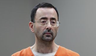 Dr. Larry Nassar appears in court for a plea hearing on Nov. 22, 2017, in Lansing, Mich. The U.S. Justice Department said Thursday, May 26, 2022, it will not pursue criminal charges against former FBI agents who failed to quickly open an investigation of the sports doctor despite learning in 2015 that he was accused of sexually assaulting female gymnasts. (AP Photo/Paul Sancya File)