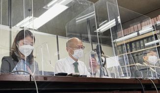 Lawyer Kenichi Ido, second left, sitting among other lawyers representing plaintiffs who were children in Fukushima at the time of the 2011 nuclear disaster and later developed thyroid cancer, speaks during a news conference after a trial in Tokyo, Thursday, May 26, 2022. A Tokyo court began hearing a case Thursday seeking nearly $5 million in damages for six people who lived as children in Fukushima and developed thyroid cancer after its 2011 nuclear disaster. (AP Photo/Mari Yamaguchi)