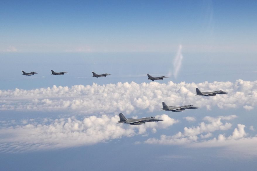 In this photo provided by the Joint Staff of the Japanese Self-Defense Force, three F-15 warplanes of the Japanese Self-Defense Force, front, and four F-16 fighters of the U.S. Armed Forces fly over the Sea of Japan on Wednesday, May 25, 2022. (Joint Staff of the Japanese Self-Defense Force via AP) ** FILE **