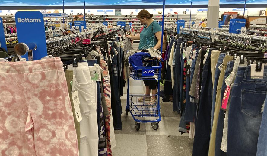 In this July 21, 2021, file photo, a consumer shops at a retail store in Morton Grove, Ill. The fastest inflation in 40 years squeezed retailers during the first quarter, alarming investors worried about the broader economy's outlook. Earnings reports from Walmart, Target and Amazon this month showed higher costs are hurting retailers' operations. (AP Photo/Nam Y. Huh) ** FILE **