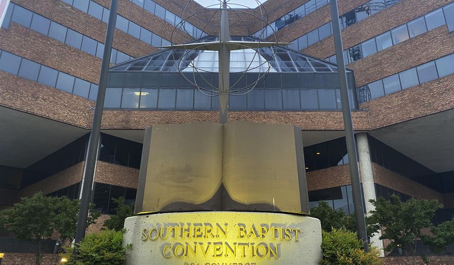 A cross and Bible sculpture stand outside the Southern Baptist Convention headquarters in Nashville, Tenn., on Tuesday, May 24, 2022. A Southern Baptist Convention sexual abuse task force bypassed calls for victim compensation on June 1, 2022, as it suggested reforms for church delegates to approve at this month’s business session in Anaheim, California. (AP Photo/Holly Meyer)