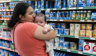 Yury Navas, 29, of Laurel, Md., kisses her two-month-old baby Jose Ismael Gálvez, at Superbest International Market in Laurel, Md., Monday, May 23, 2022, while looking for formula. After this day&#x27;s feedings she will be down to the last 12.5-ounce container. The only formula he can take without digestive issues, Enfamil Infant, has been almost impossible for her to find. Navas doesn&#x27;t know why her breastmilk didn&#x27;t come in for her third baby and has tried many brands of formula before finding the one kind that he could tolerate. Though the baby food aisle had plenty of options for older babies, the kind she needs was nowhere in sight. (AP Photo/Jacquelyn Martin) **FILE**