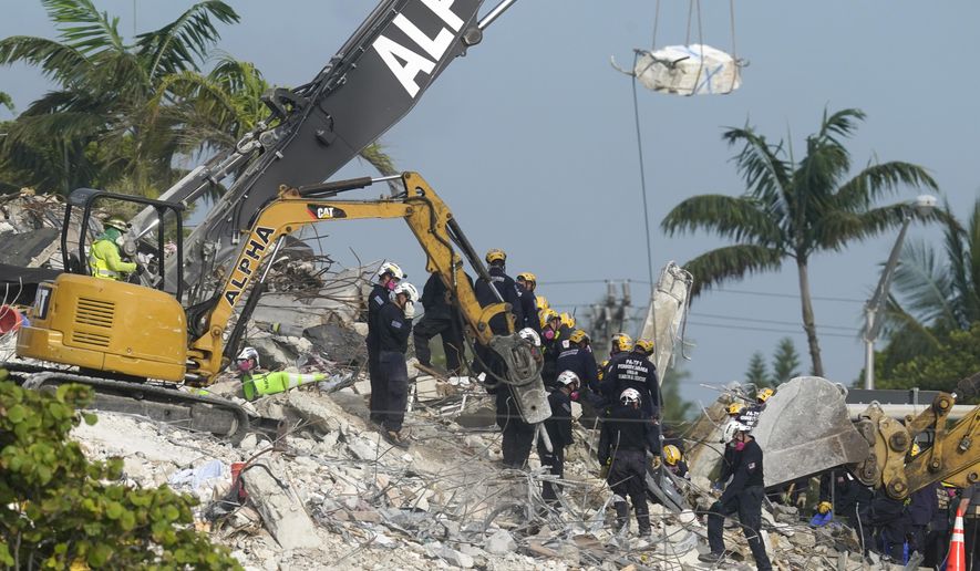 Rescue crews work at the site of the collapsed Champlain Towers South condo building after the remaining structure was demolished Sunday, in Surfside, Fla., Monday, July 5, 2021. Attorneys for the families who lost relatives or homes in last year’s collapse of a Florida condominium tower that killed 98 people finalized a $1 billion settlement on Friday, May 27, 2022. (AP Photo/Lynne Sladky, File)
