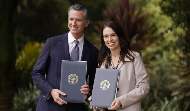 California Gov. Gavin Newsom and New Zealand Prime Minister Jacinda Ardern pose with agreements they signed at the San Francisco Botanical Garden in San Francisco, Friday, May 27, 2022.  Gov. Newsom met with Ardern in Golden Gate Park &amp;quot;to establish a new international partnership tackling climate change.&amp;quot; (AP Photo/Eric Risberg)