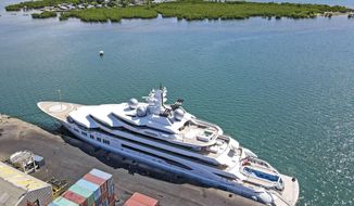 The superyacht Amadea is docked at the Queens Wharf in Lautoka, Fiji, on April 15 2022. On May 5, five U.S. federal agents boarded the massive Russian-owned superyacht Amadea that was berthed in Lautoka harbor in Fiji in a case that is highlighting the thorny legal ground the U.S. is finding itself on as it tries to seize assets of Russian oligarchs around the world. (Leon Lord/Fiji Sun via AP, File)