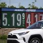 Gasoline prices are displayed outside a convenience store as a motorist drives by on Thursday, May 26, 2022, in Thornton, Colo. Experts are expecting a flush of travelers at airports and on the nation&#39;s byways during the long Memorial Day weekend, which marks the start of the summer travel season, in spite of high fuel costs. (AP Photo/David Zalubowski)