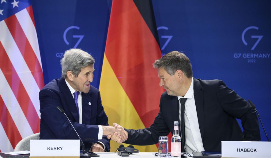 German Economy and Climate Minister Robert Habeck, right, and John Kerry, left, Special Envoy of the U.S. President for Climate, shake hands after they signed a declaration of intent to establish a German-American climate and energy partnership between the United States of America and Germany at the meeting of the G7 Ministers for Climate, Energy and Environment in Berlin, Germany, Monday, May. 27, 2022. (Bernd von Jutrczenka/dpa/dpa via AP)