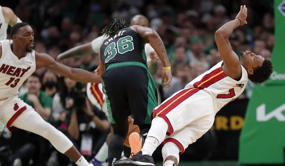 Miami Heat&#39;s Kyle Lowry (7) fouls Boston Celtics&#39; Marcus Smart (36) during the first half of Game 6 of the NBA basketball playoffs Eastern Conference finals Friday, May 27, 2022, in Boston. (AP Photo/Michael Dwyer)