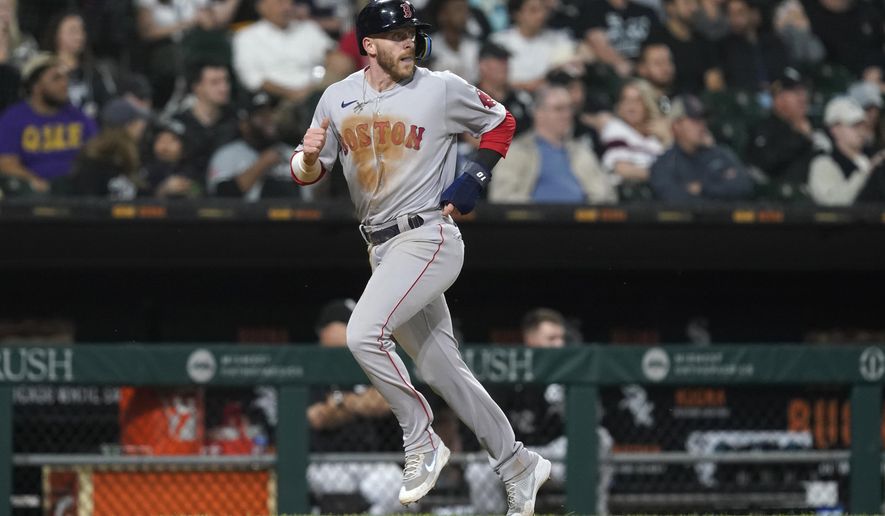 Boston Red Sox&#39;s Trevor Story looks back at Alex Verdugo as he scores on Verdugo&#39;s double during the fifth inning of the team&#39;s baseball game against the Chicago White Sox on Thursday, May 26, 2022, in Chicago. (AP Photo/Charles Rex Arbogast)