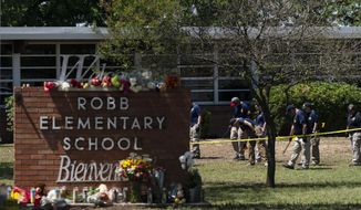 Investigators search for evidence outside Robb Elementary School in Uvalde, Texas, May 25, 2022. The children who survived the attack, which killed 19 schoolchildren and two teachers, described a festive, end-of-the-school-year day that quickly turned to terror. (AP Photo/Jae C. Hong, File)