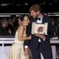 Writer/director Ruben Ostlund, winner of the Palme d&#39;Or for &#39;Triangle of Sadness,&#39; poses with Dolly De Leon, left during the photo call following the awards ceremony at the 75th international film festival, Cannes, southern France, Saturday, May 28, 2022. (Photo by Vianney Le Caer/Invision/AP)