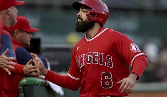 Los Angeles Angels&#39; Anthony Rendon (6) is congratulated after scoring against the Oakland Athletics on a single by Brandon Marsh during the fourth inning of a baseball game in Oakland, Calif., Friday, May 13, 2022. (AP Photo/Jed Jacobsohn)