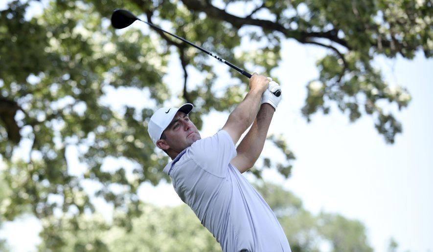 Scottie Scheffler watches his shot off the third hole during the third round of the Charles Schwab Challenge golf tournament at the Colonial Country Club, Saturday, May 28, 2022, in Fort Worth, Texas. (AP Photo/Emil Lippe)