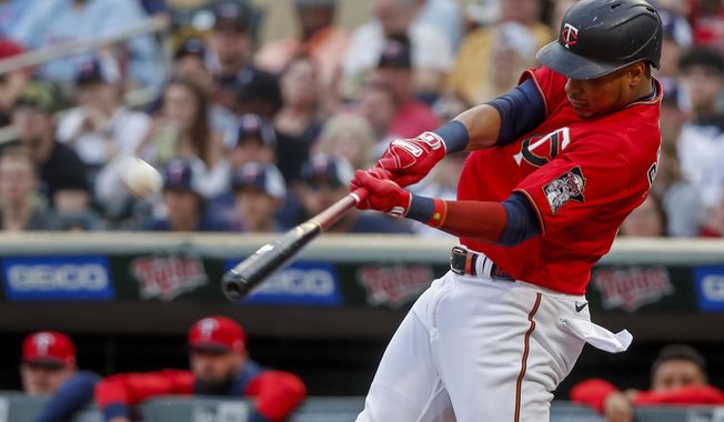 Minnesota Twins&#x27; Jorge Polanco hits a two-run home run against the Kansas City Royals during the first inning of a baseball game Friday, May 27, 2022, in Minneapolis. (AP Photo/Bruce Kluckhohn)
