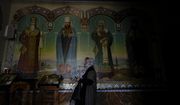 A woman prays at the Kyiv Pechersk Lavra Monastery in Kyiv, Ukraine, Saturday, May 28, 2022. The leaders of the Orthodox churches in Ukraine that were affiliated with the Russian Orthodox Church have announced on a statement they will sever ties with Russia over its invasion of Ukraine. (AP Photo/Natacha Pisarenko)
