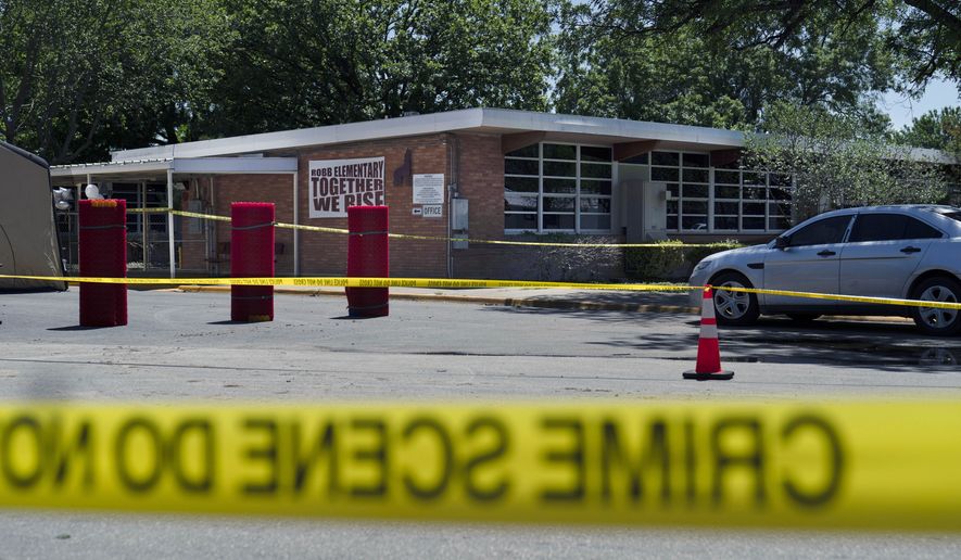 Crime scene tape surrounds Robb Elementary School after a mass shooting in Uvalde, Texas, May 25, 2022. (AP Photo/Jae C. Hong, File)