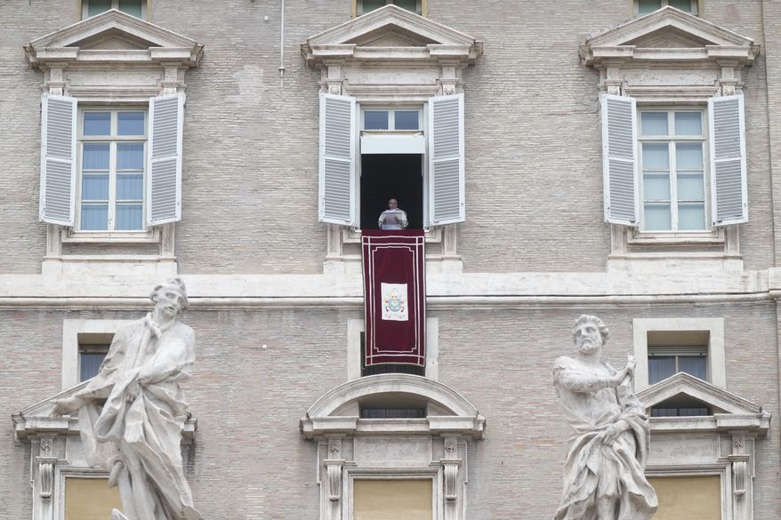Pope Francis delivers the Regina Coeli noon prayer from his studio window overlooking St. Peter's Square at the Vatican, Sunday, 29, 2002. (AP Photo/Gregorio Borgia)