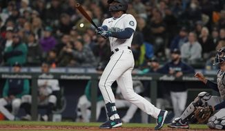 Seattle Mariners&#x27; Kyle Lewis watches his a solo home run against the Houston Astros during the second inning of a baseball game, Saturday, May 28, 2022, in Seattle. (AP Photo/Ted S. Warren)