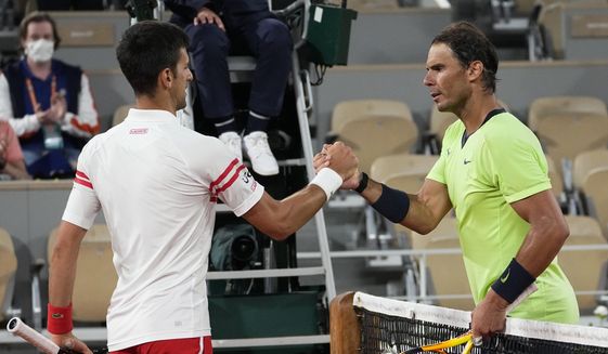 Serbia&#39;s Novak Djokovic, left, shakes hands with Spain&#39;s Rafael Nadal after their semifinal match of the French Open tennis tournament at the Roland Garros stadium, Friday, June 11, 2021 in Paris. When Djokovic and Nadal meet in the French Open quarterfinals on Tuesday, May 31, 2022, it will be their 59th career matchup, more than any other two men in the professional era of tennis, and their first showdown since last year&#39;s semifinals at Roland Garros. (AP Photo/Michel Euler, Filer) ** FILE**