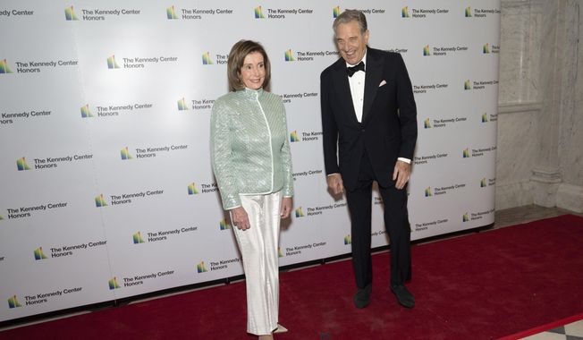 House Speaker Nancy Pelosi, D-Calif., and her husband, Paul Pelosi, pose on the red carpet at the Medallion Ceremony for the 44th Annual Kennedy Center Honors on Saturday, Dec. 4, 2021, at the Library of Congress in Washington. (AP Photo/Kevin Wolf) ** FILE **