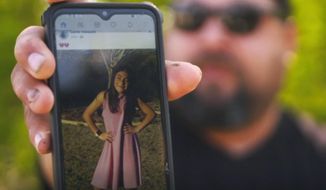 In this image from video, Javier Cazares shows a picture of his daughter, Jackie Cazares, Thursday, May 26, 2022, in Uvalde, Texas. Jackie, 9, was among the 19 children and two teachers killed during a mass shooting at Robb Elementary School on Tuesday. (AP Photo/Robert Bumsted)
