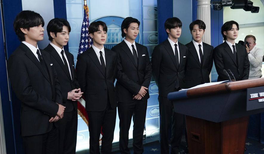 Members of the K-pop supergroup BTS, from left, V, Jungkook, Jimin, RM, Jin, J-Hope, Suga, join White House press secretary Karine Jean-Pierre during the daily briefing at the White House in Washington, Tuesday, May 31, 2022. (AP Photo/Susan Walsh)