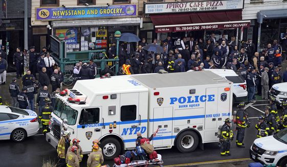 Emergency personnel gather at the entrance to a subway station in the Brooklyn borough of New York, after a gunman filled a rush-hour subway train with smoke and shot multiple people, April 12, 2022. A woman wounded in the shooting has filed a lawsuit against gun manufacturer Glock. (AP Photo/John Minchillo, File)